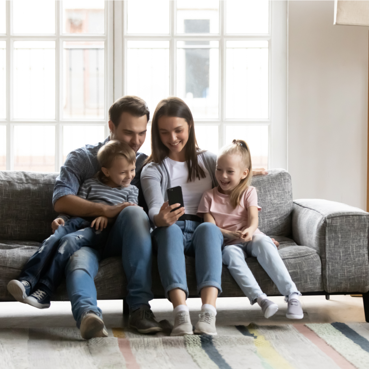 A family relaxing comfortably on their couch at home (image published on Pilot's own site)