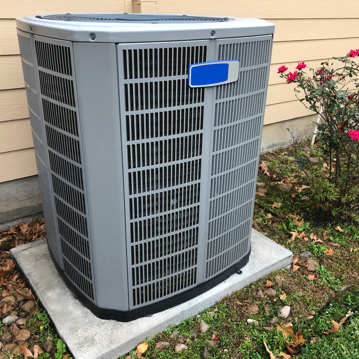 Outdoor air conditioning condenser installed beside a home